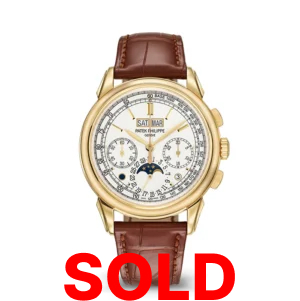 A gold watch with brown leather strap and white face.