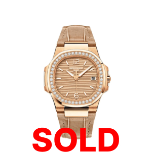 A gold watch with a diamond bezel and leather strap.