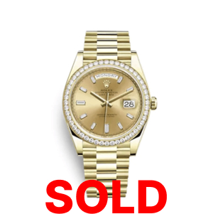 A gold rolex watch with the date and day