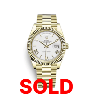 A gold rolex watch with the date and roman numeral dial.